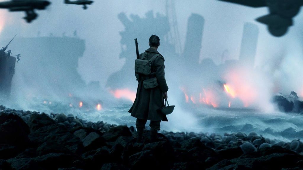 soldier standing in a battlefield surrounded by rubble and fire