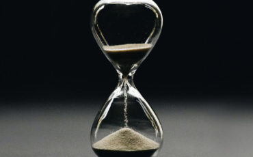 Transparent hourglass with sand falling