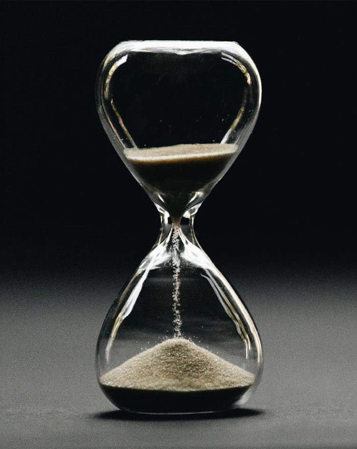 Transparent hourglass with sand falling