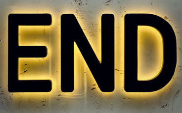 Black END sign with neon yellow backlighting