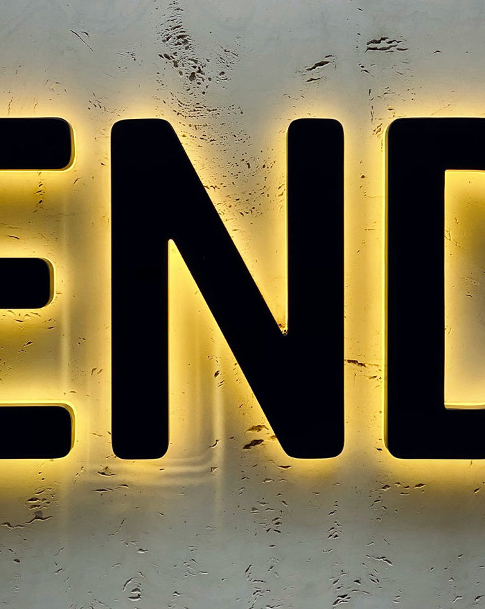 Black END sign with neon yellow backlighting