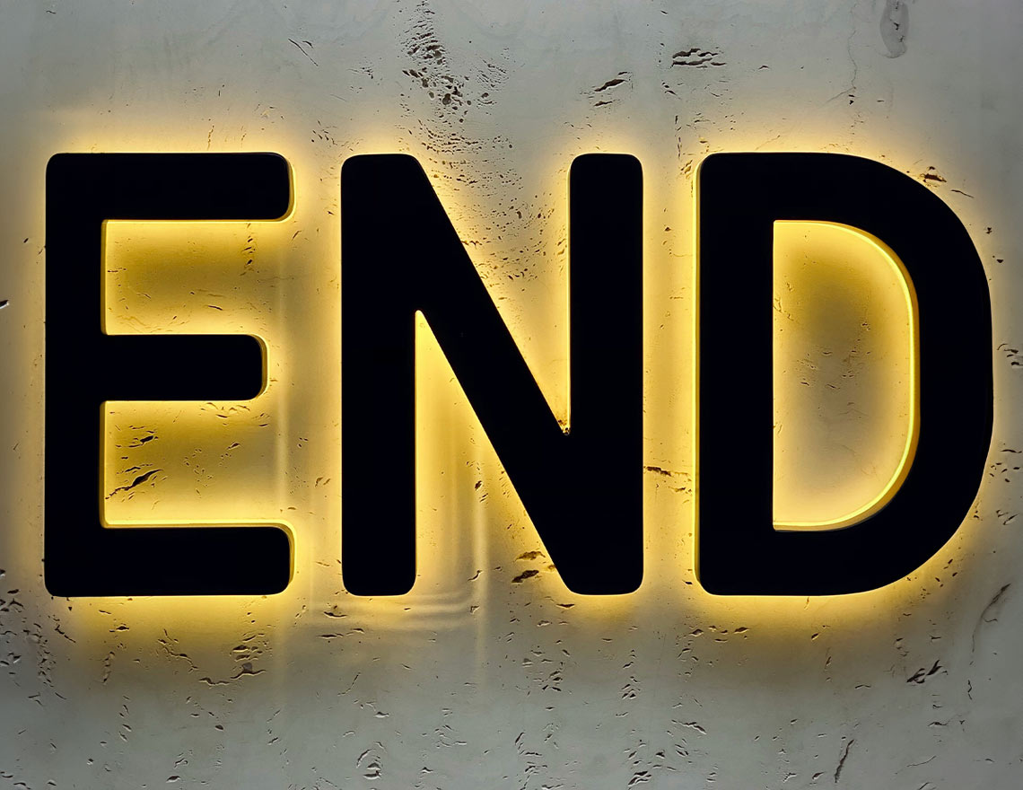 Black END sign with neon yellow backlighting