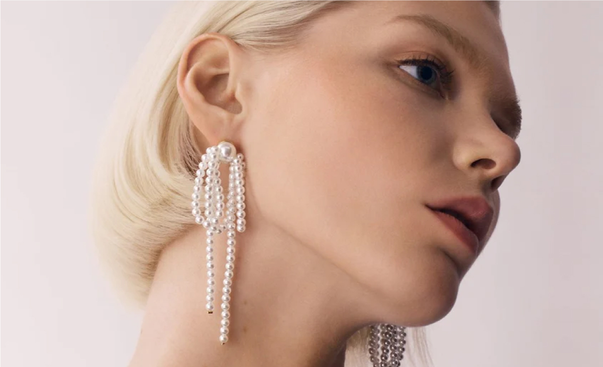 Orelia face with pearl drop earrings - client of long story short design agency