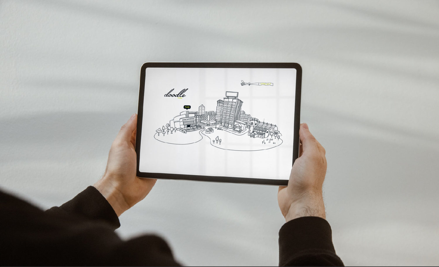 Doodle Films - hands holding iPad - client of long story short design agency